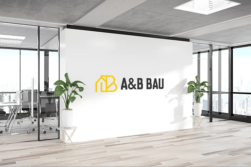 A&B Bau Logo an einer weißen Bürowand